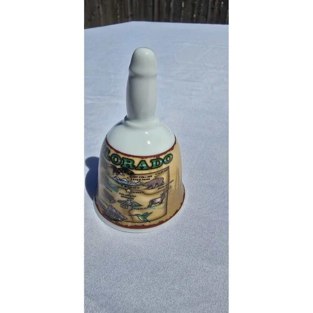 vintage/collectible porcelain souvenir bell featuring a map graphic of Colorado
